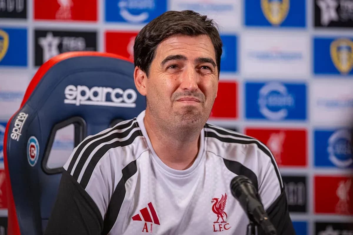 Manager at press conference with Liverpool branding