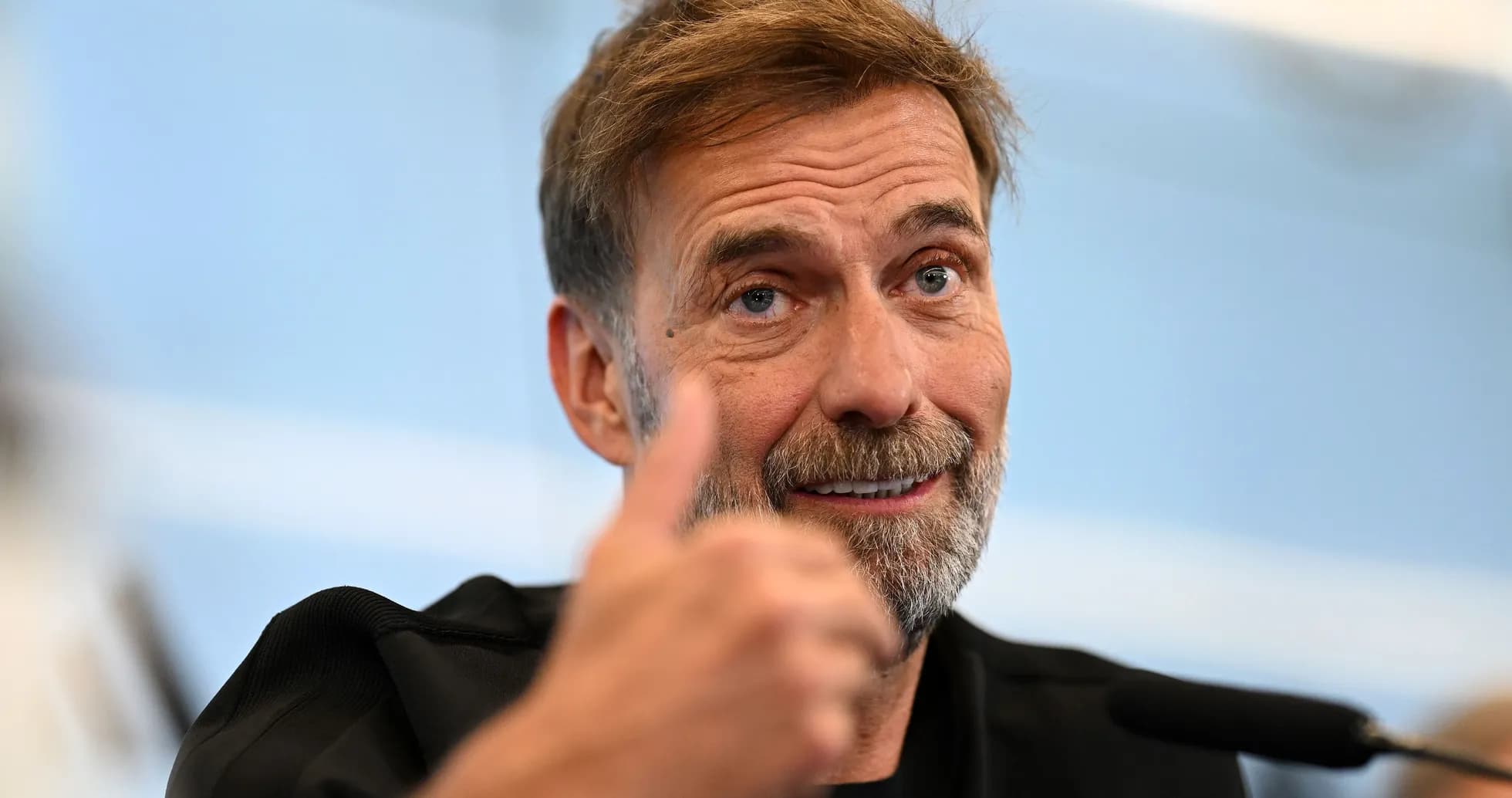 Manager giving a thumbs up at press conference