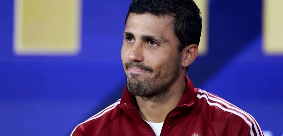 Player in red jacket during press conference