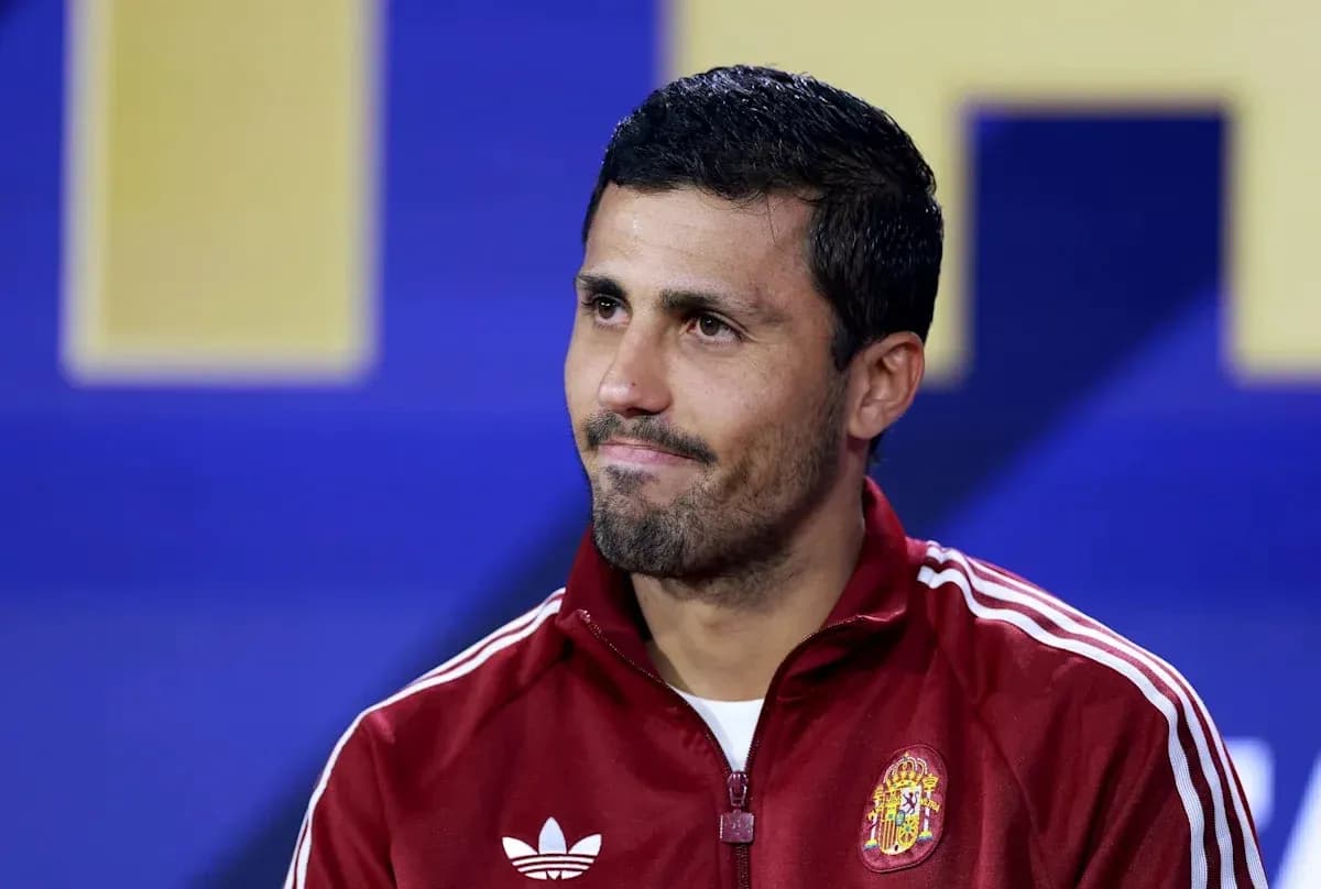 Player in red jacket during press conference