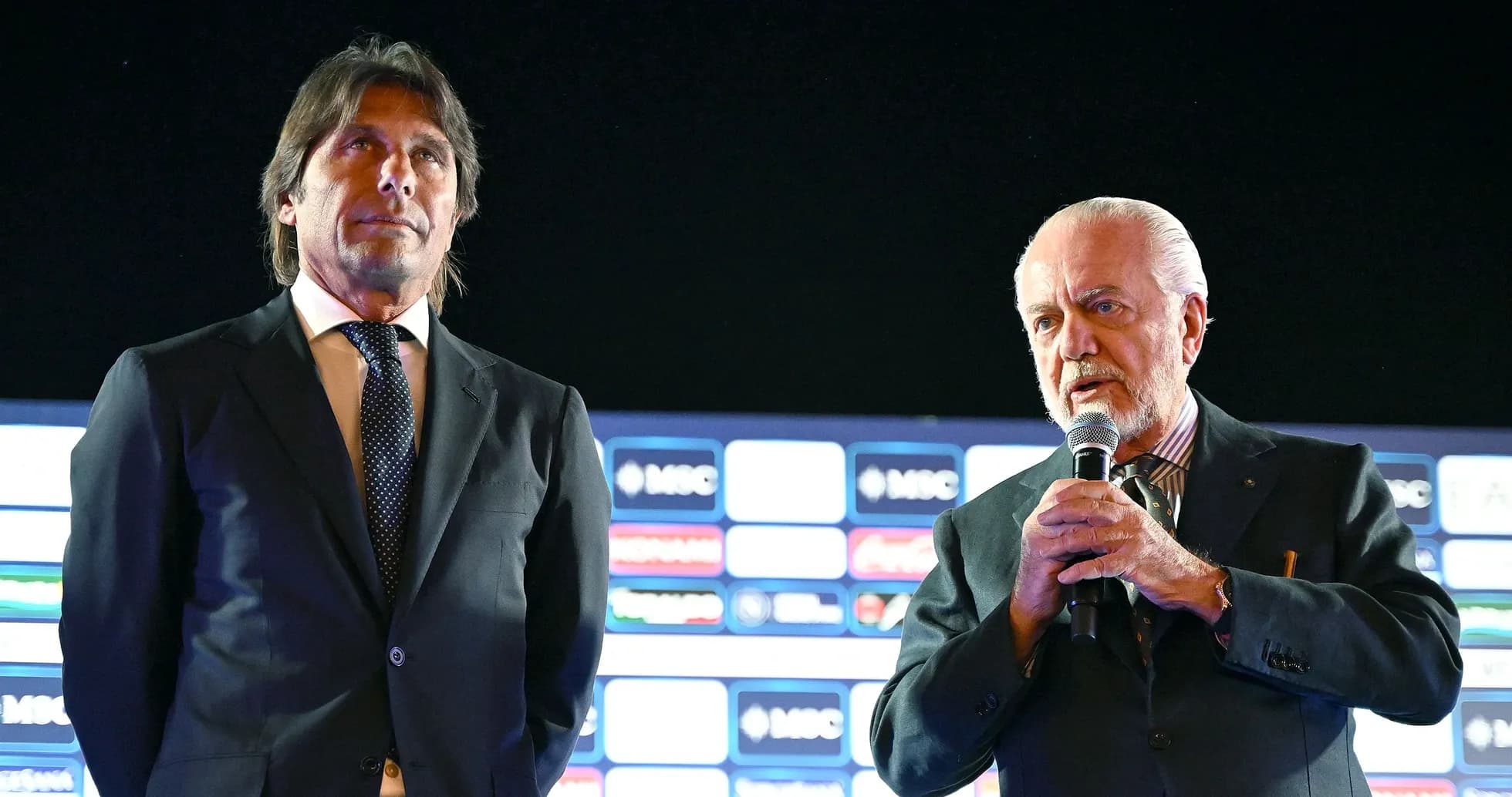 Two men on stage during a press event