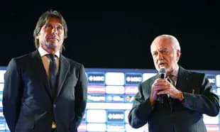 Two men on stage during a press event