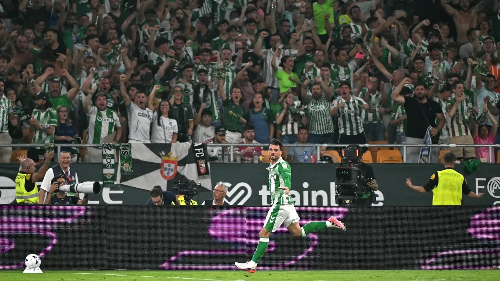 Player celebrating a goal in front of fans