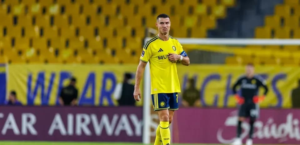 Player in yellow kit standing on the field