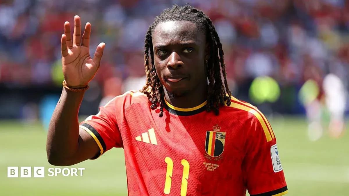 Player waving while wearing Belgium national team jersey