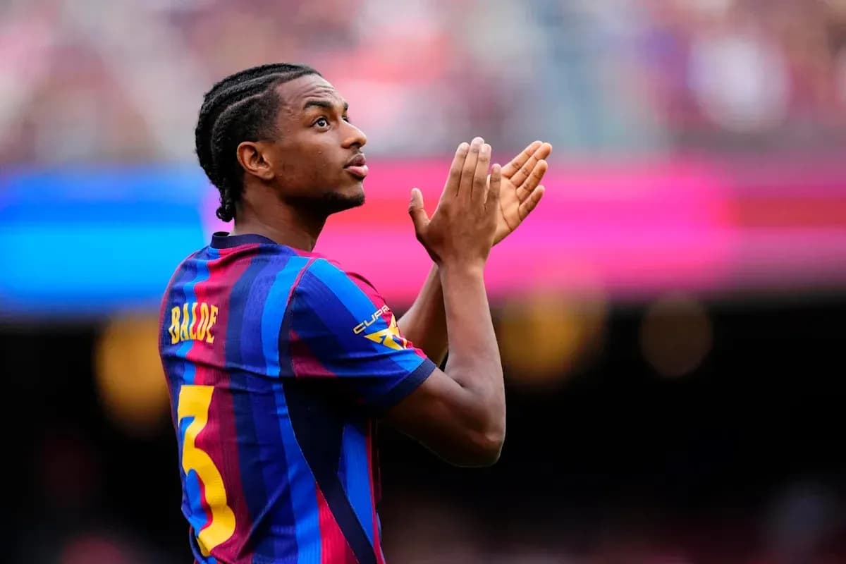 Player with hands clasped looking upward on field