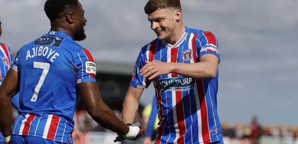 Two players celebrating during a football match