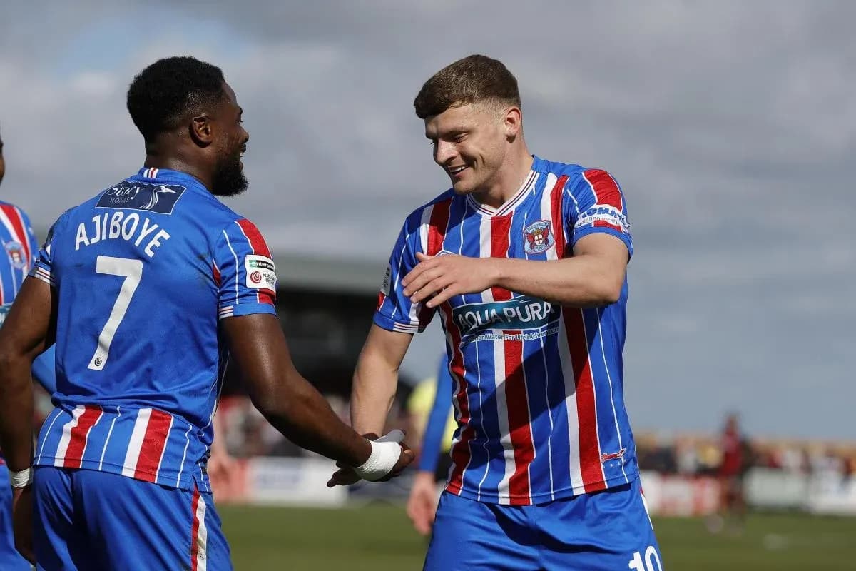 Two players celebrating during a football match