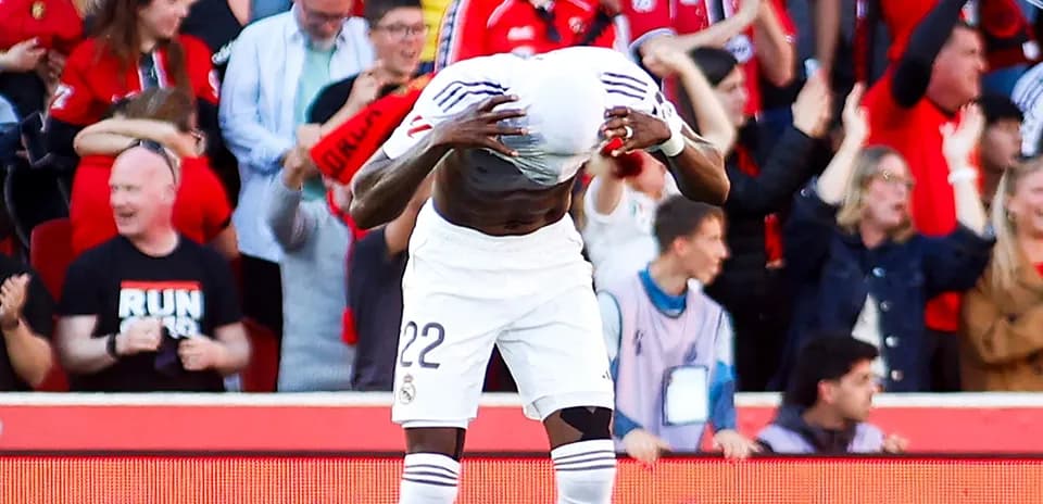 Player celebrating goal in front of cheering fans