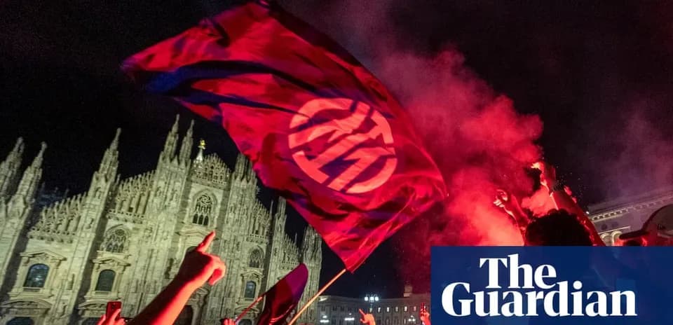 Fans celebrating with flag in front of cathedral
