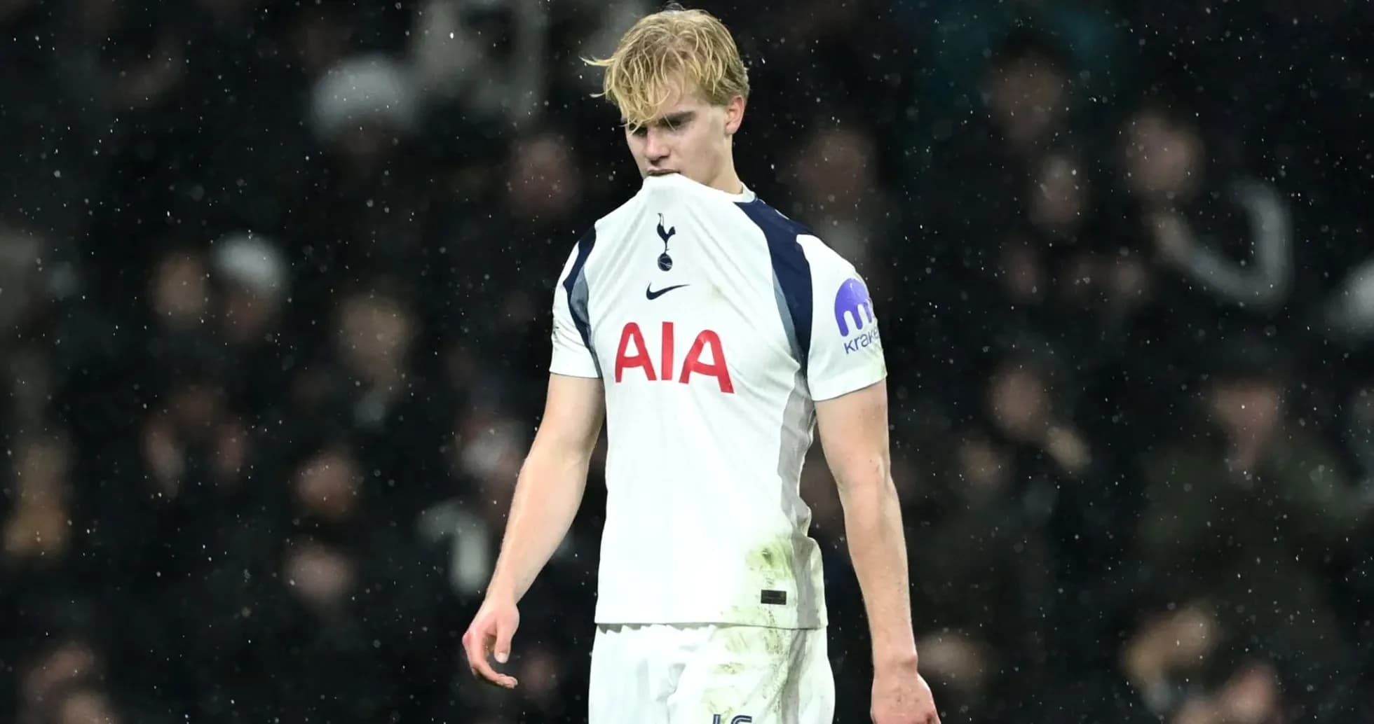 Player in Tottenham kit during rainy match