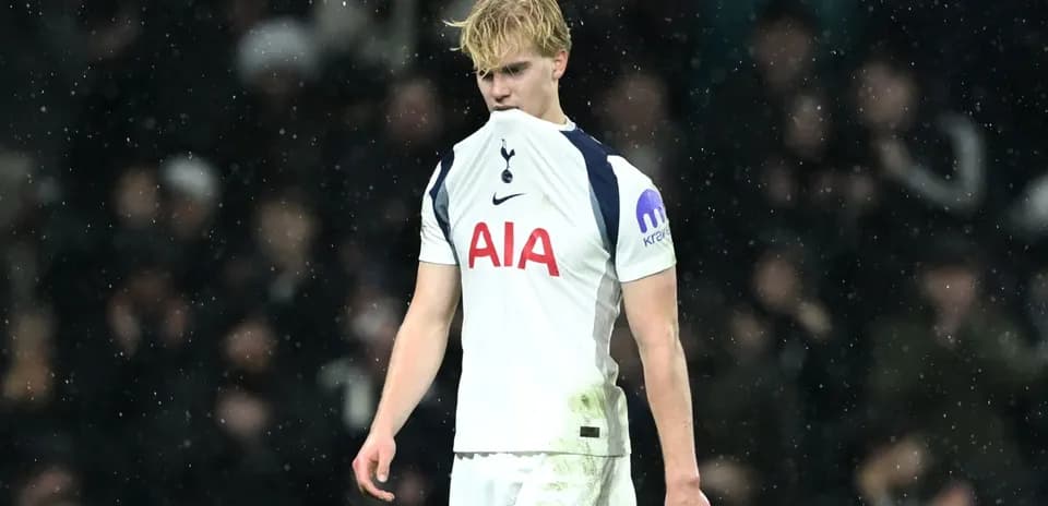 Player in Tottenham kit during rainy match