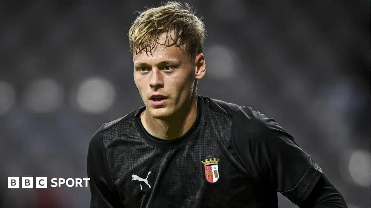 Goalkeeper in black kit during match warm-up