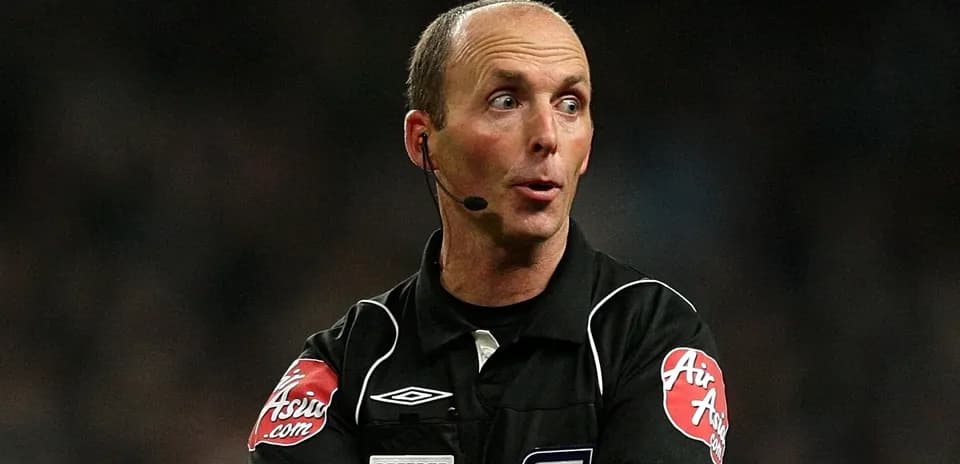 Referee officiating a match with microphone and gestures