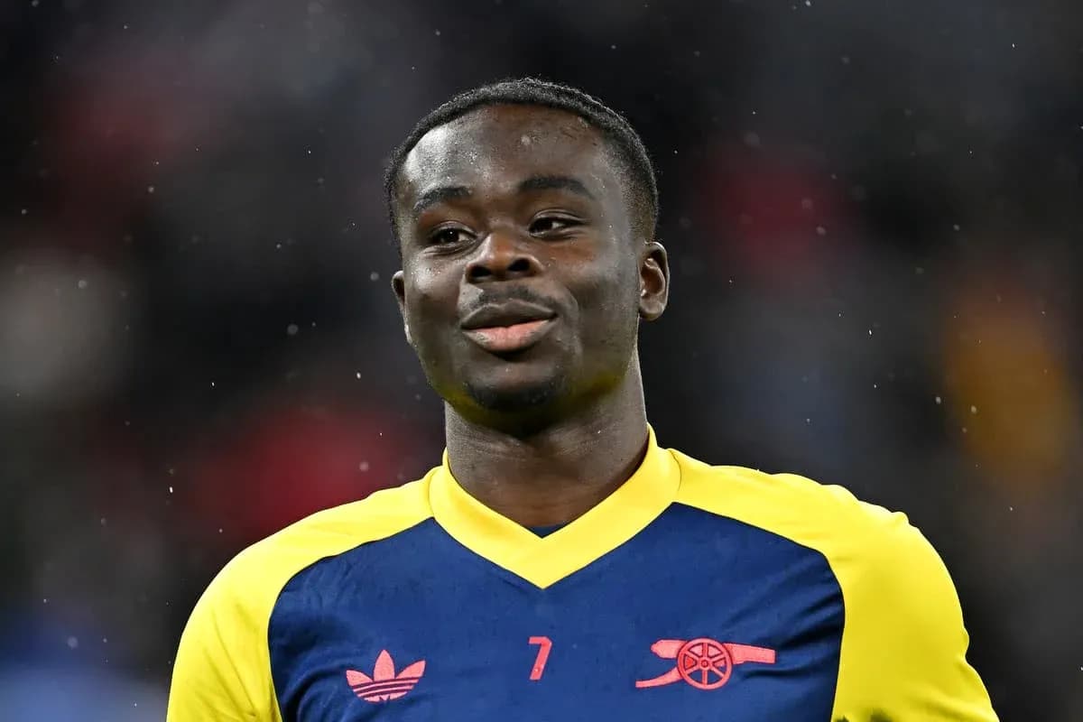 Player in Arsenal jersey smiling on the field