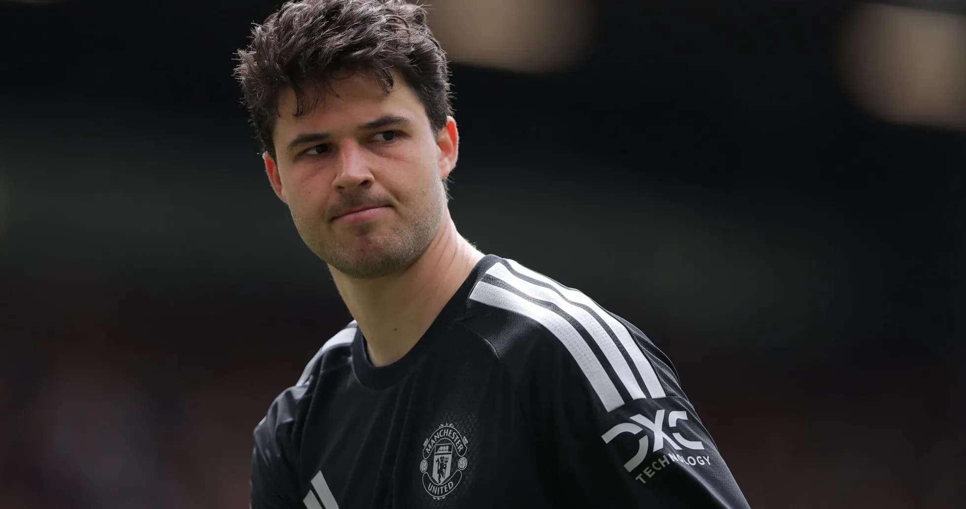 Goalkeeper wearing Manchester United kit on field