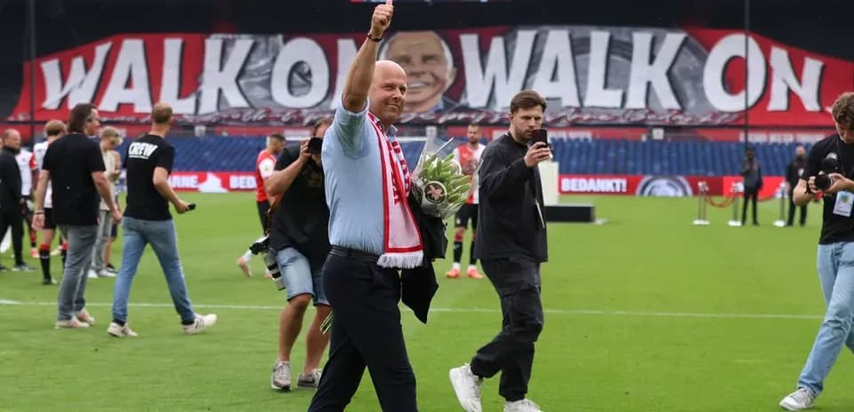 Man waving with bouquet in stadium celebration