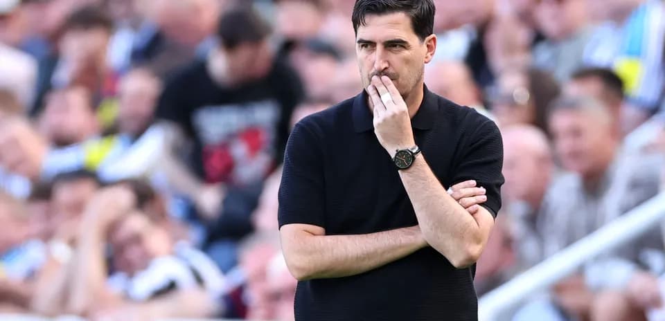 Coach observing the match with thoughtful expression
