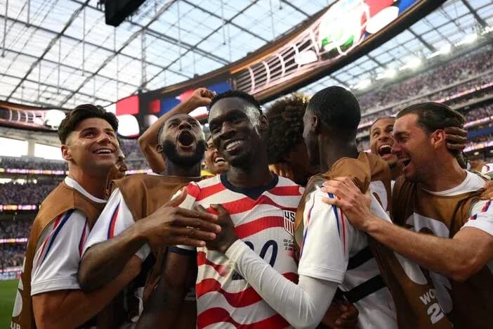 US men's soccer team celebrating a goal together