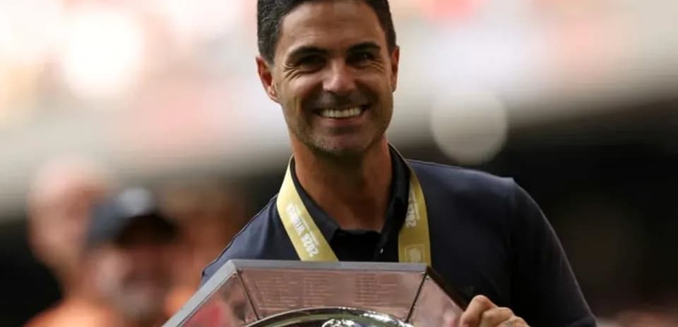 Manager holding trophy during victory celebration