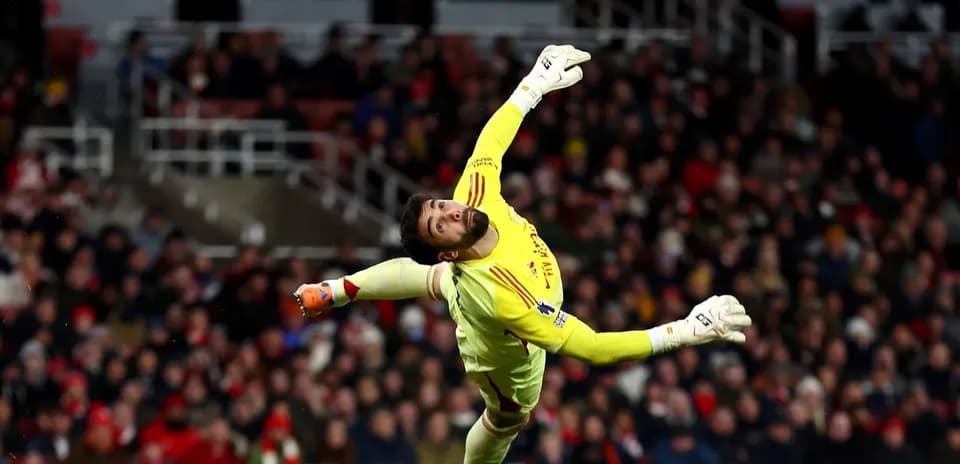 Goalkeeper diving to save the ball during match