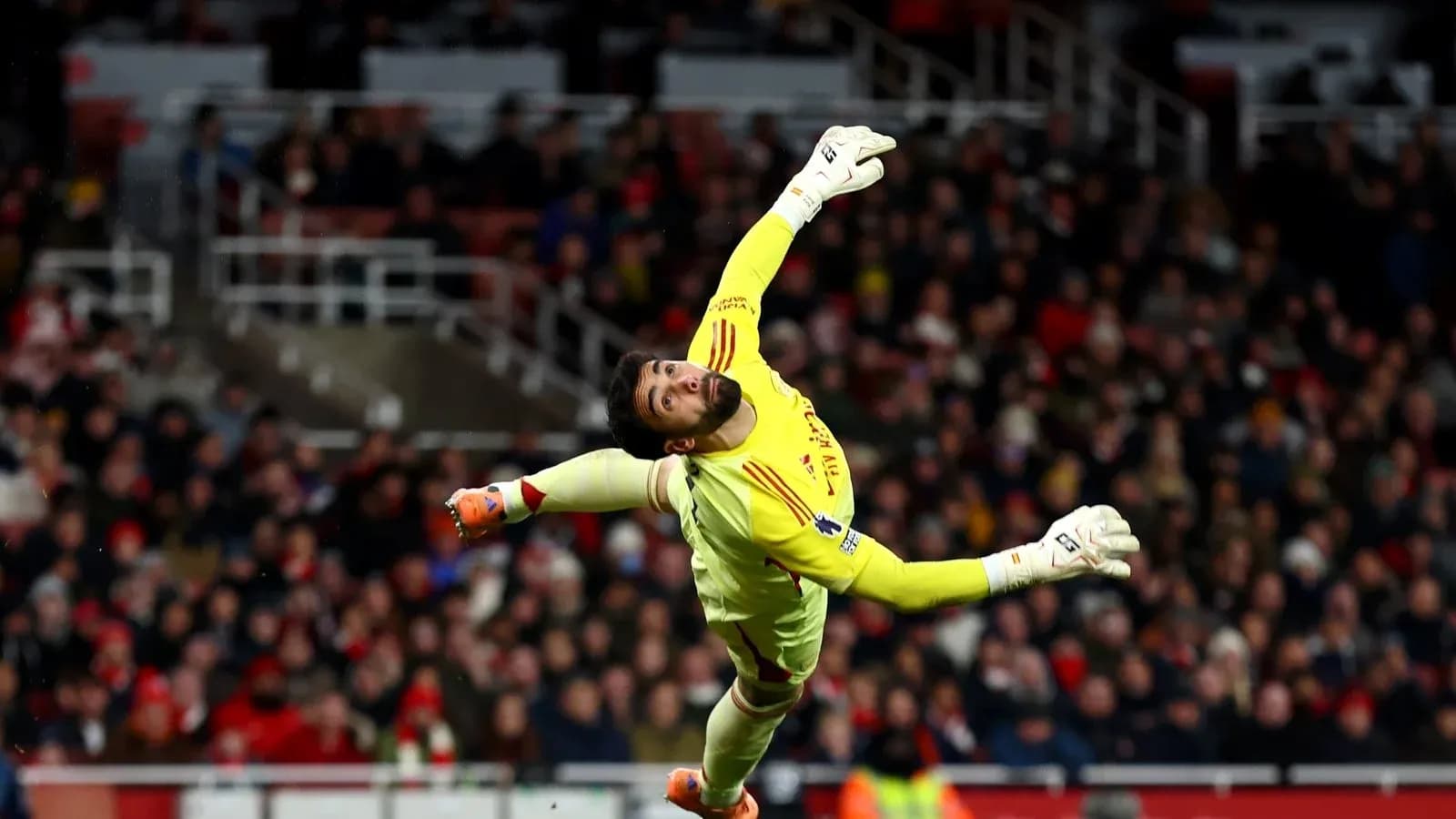 Goalkeeper diving to save the ball during match