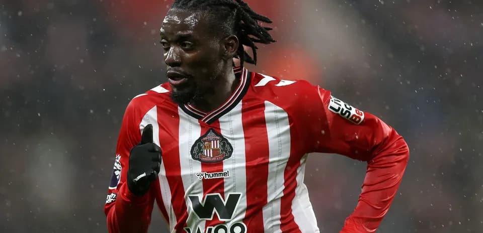 Sunderland player running in the rain during match