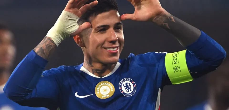 Chelsea player celebrating with hands raised