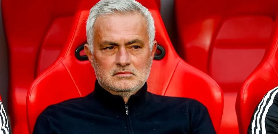 Coach sitting on bench during match