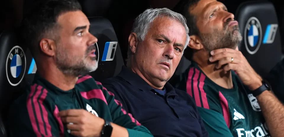 Coaches sitting on the bench during a match