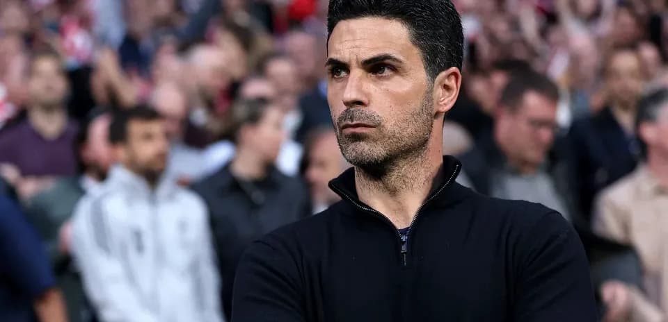 Coach observing the match with fans in background