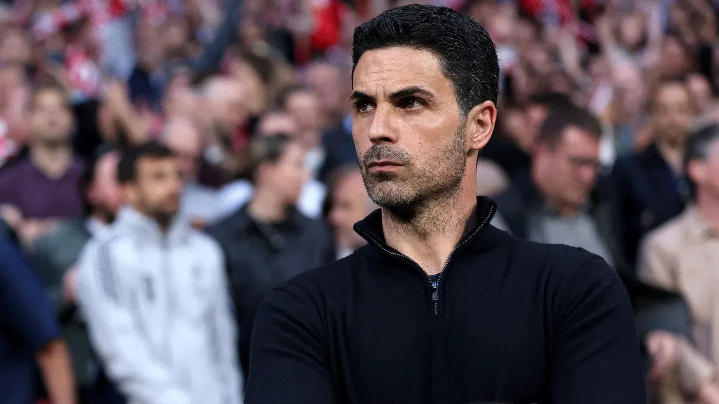 Coach observing the match with fans in background