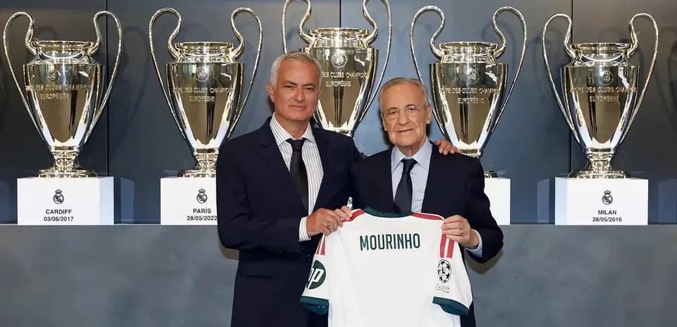 Jose Mourinho presenting jersey with trophies backdrop