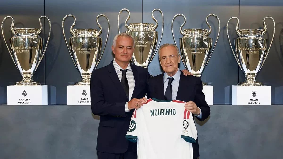 Jose Mourinho presenting jersey with trophies backdrop