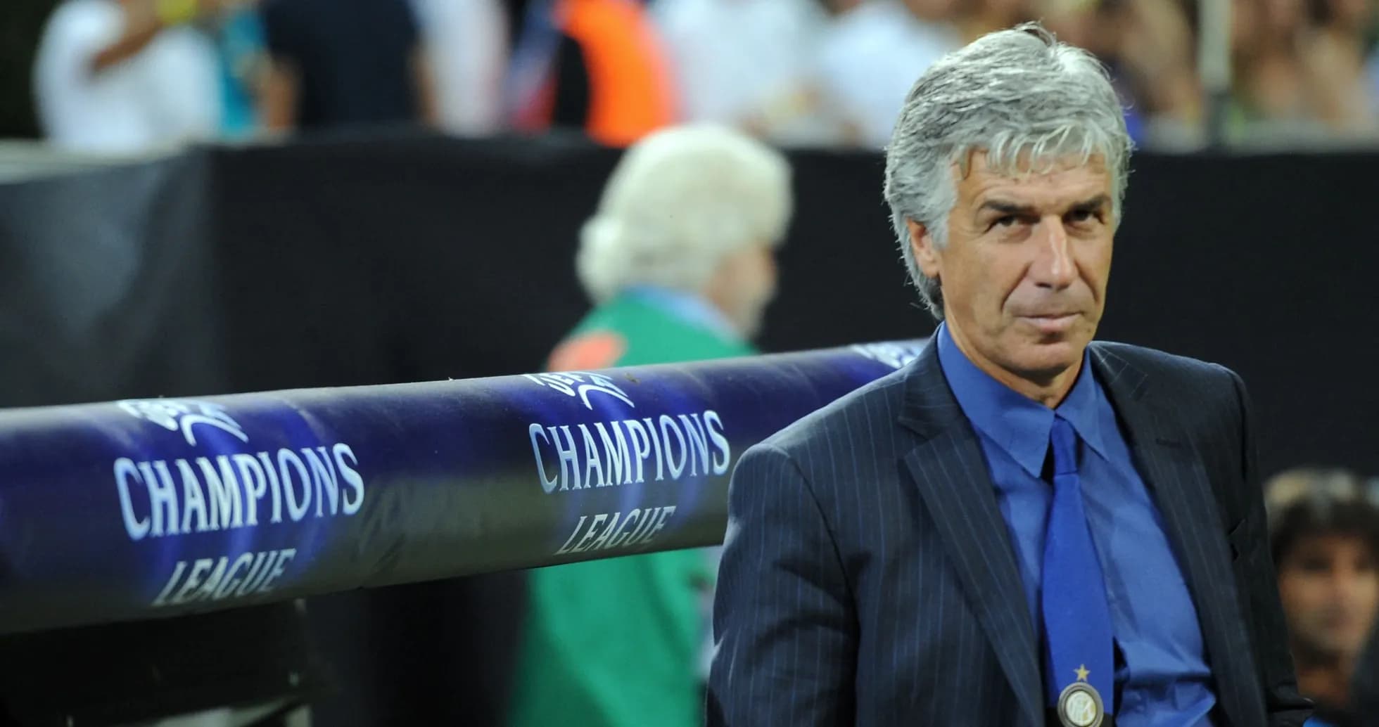 Coach seated on bench during Champions League match