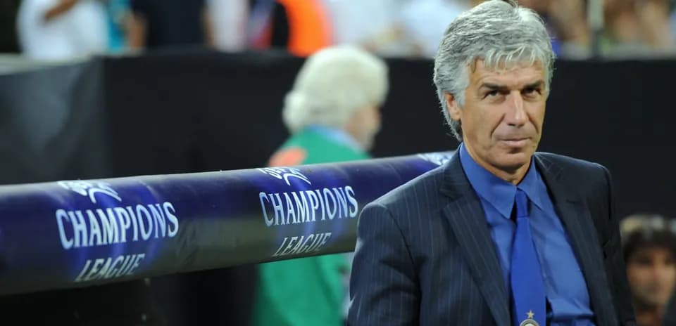 Coach seated on bench during Champions League match