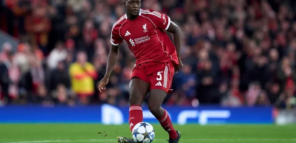 Player in Liverpool kit dribbling ball on pitch