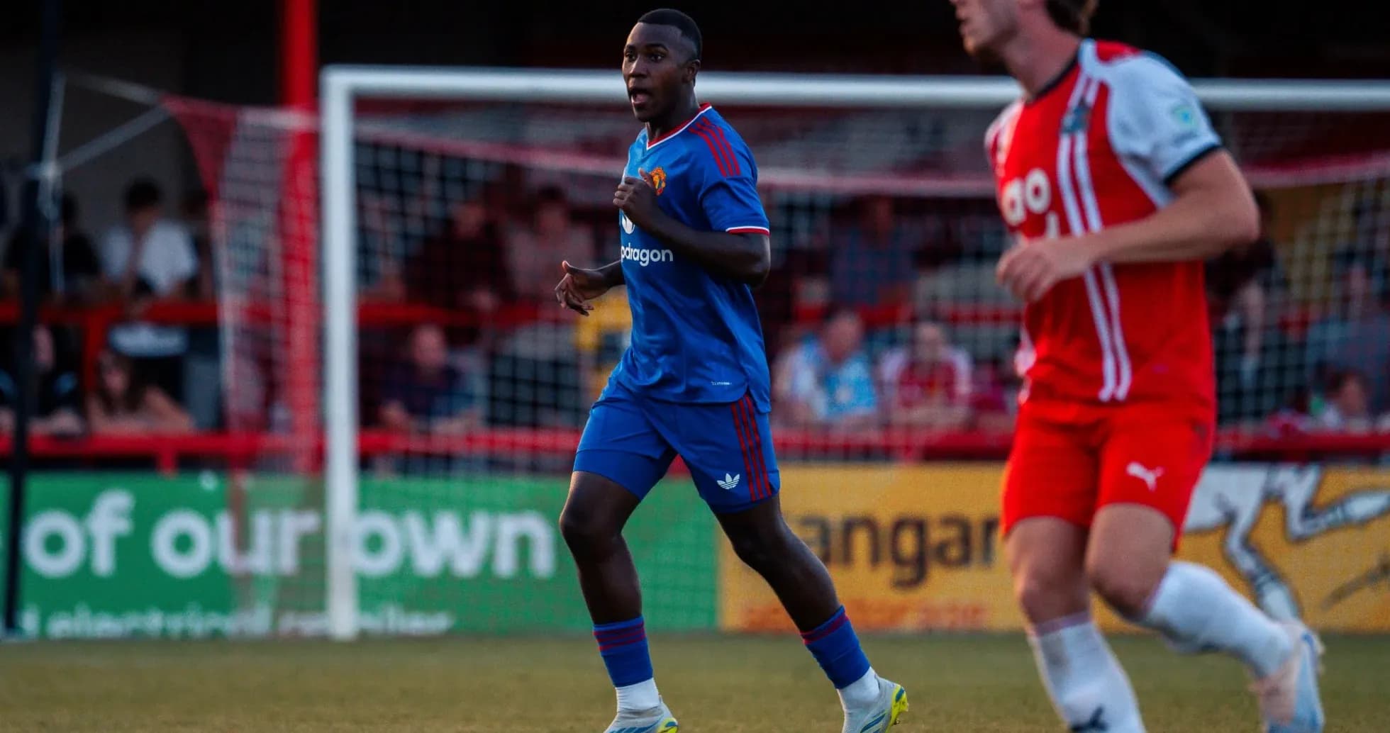 Player in blue kit running during a match