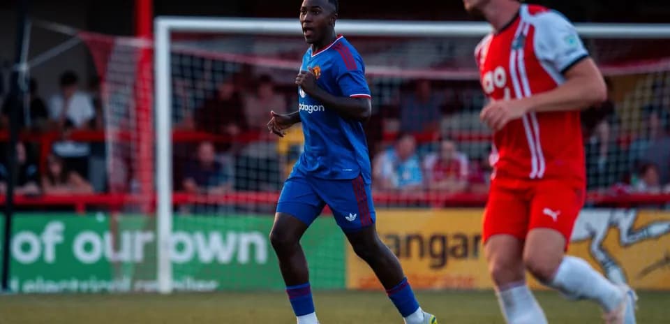 Player in blue kit running during a match