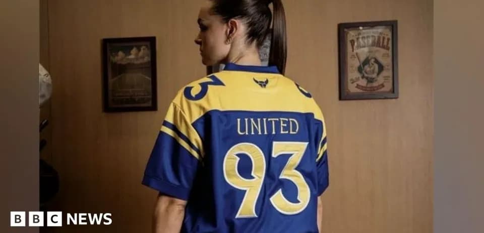 Person wearing a blue and yellow jersey with '93' and 'UNITED' on back