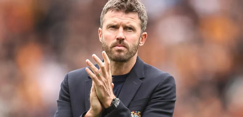 Coach clapping during a match at the stadium