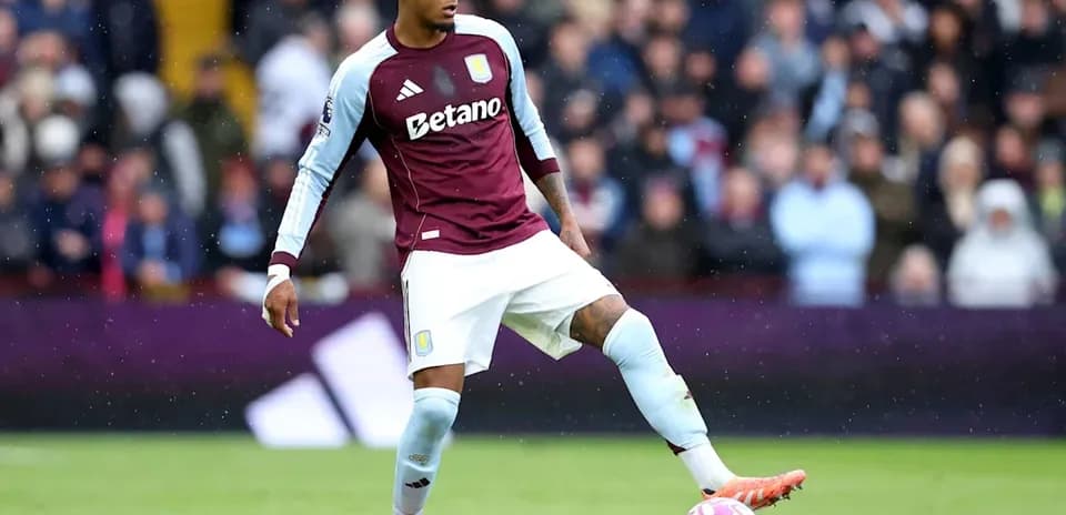 Player in Aston Villa kit controlling the ball