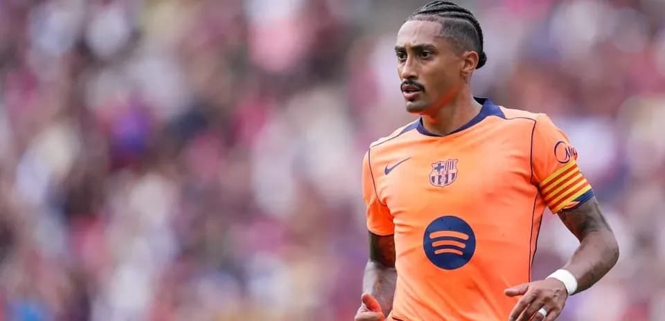Player in orange Barcelona kit running on field
