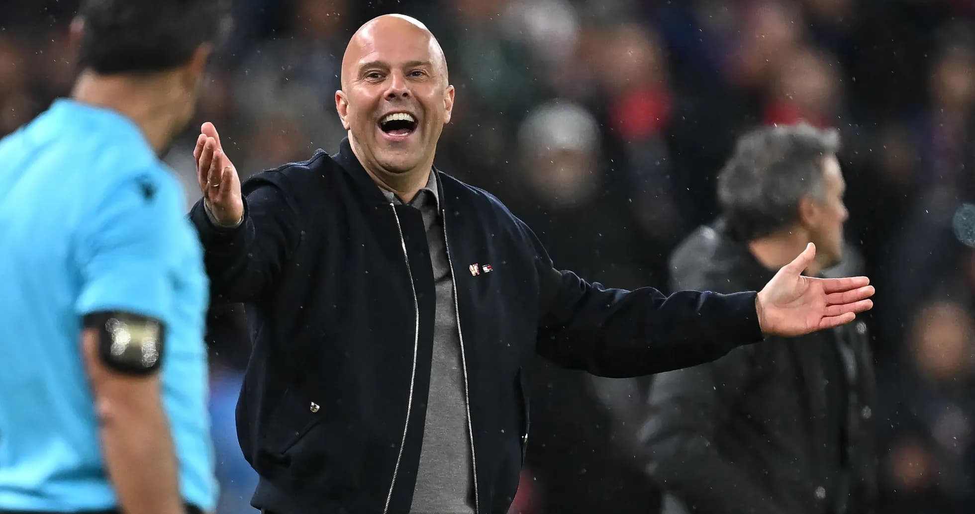 Coach gesturing while speaking to referee during match