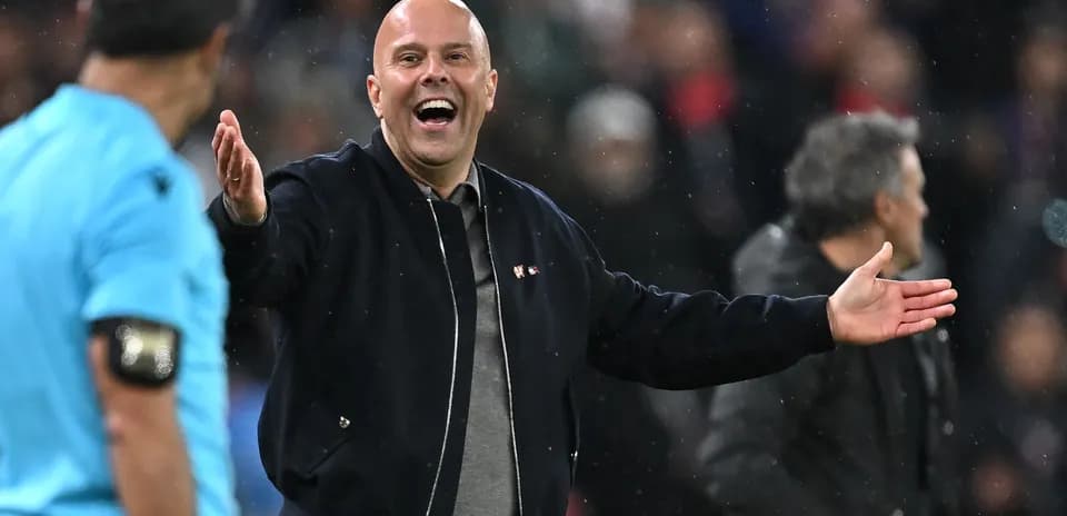 Coach gesturing while speaking to referee during match