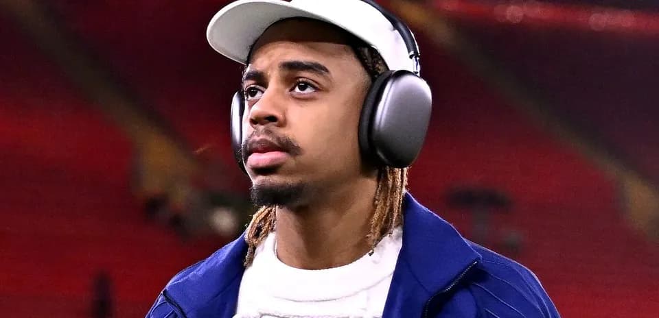 Player wearing headphones walking on stadium field