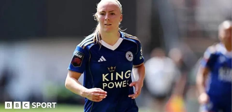 Female player in blue kit running on field