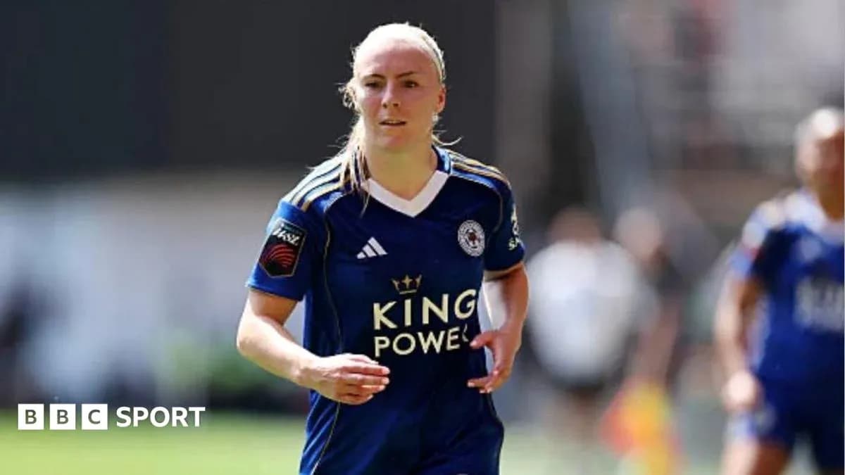 Female player in blue kit running on field