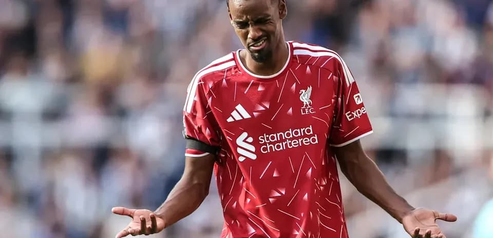 Player in Liverpool kit reacting during match