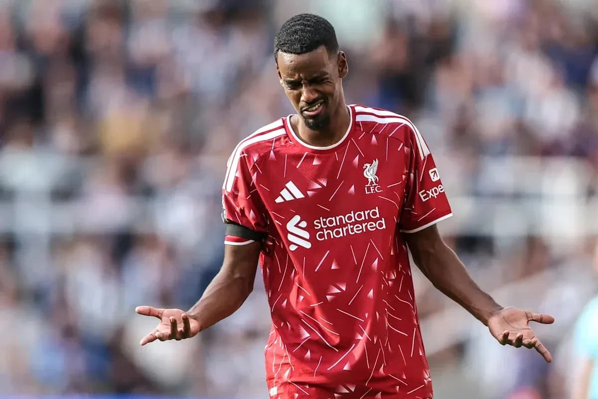Player in Liverpool kit reacting during match